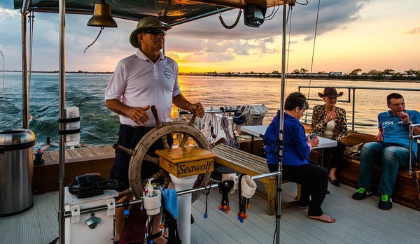 Scott driving the boat at sunset